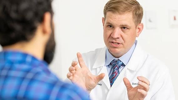 Dr. Lundy counseling a patient in clinic